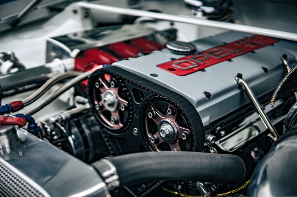 Work Detailed image showing the inner workings of an Opel car engine with components in focus.